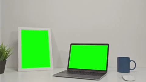 Two elecronic devices: laptop computer and tablet with green screen on a white Stock Footage 148544663