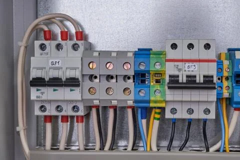Two electric circuit breakers and terminals with connected wires. Stock Photos