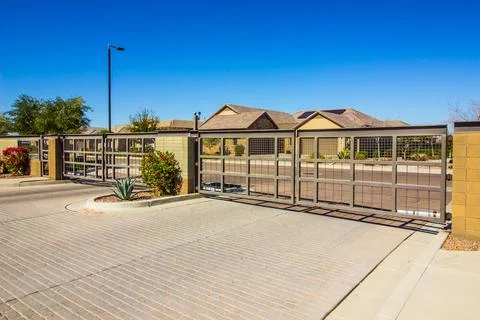 Two Electric Entry/Exit Gates With Brick Driveway Stock Photos