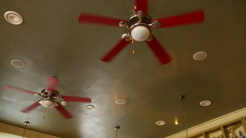 Two electric fans spin on the ceiling in a cafe, camera movement Stock Footage 135311628