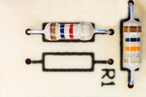 Two electrical resistors with various colored stripes. Stock Photos
