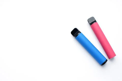 Two electronic cigarettes on a white background. Place for your text. Stock Photos