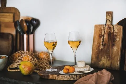 Two elegant glasses of Orange or Amber wine and appetizers Stock Photos