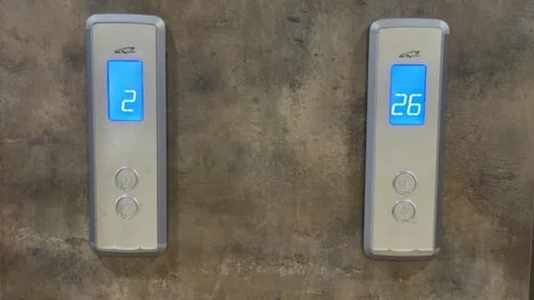 Two elevator control panels with lit digital floor indicators against textu.. Stock Footage 338324506