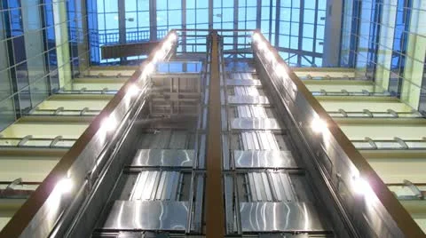 Two elevators go to business-center where light in windows of offices is shone Stock Footage 10808251