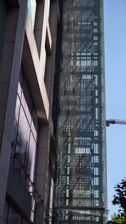 Two elevators move simultaneously up and down from the outside of the building. Stock Footage 284398222