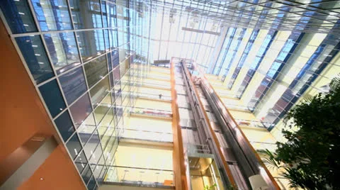 Two elevators ride at multilevel building with transparent roof Stock Footage 22733015