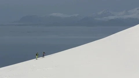 Two elite hikers climbing a snow covered mountain peak Stock Footage 113224326