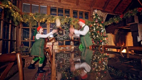 Two elves are standing in specially decorated room near the table Video stock 118249859