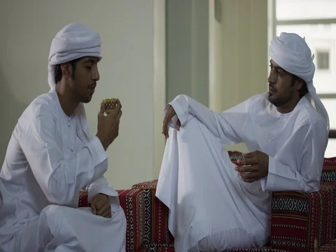 Two Emirati men sitting together drinking tea. Stock Footage 83202861