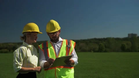 Two employees of an alternative power plant talking about a scheme of solar p Stock Footage 215972719