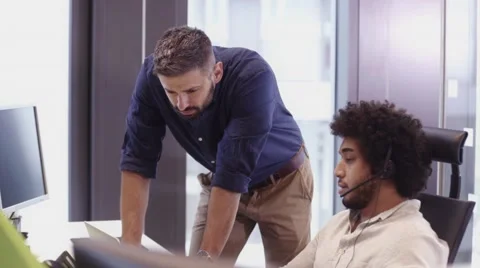 Two employees discussing business problems at desk Stock Footage 67386201