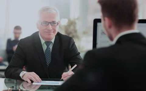 Two employees discussing electronic data at meeting Stock Photos