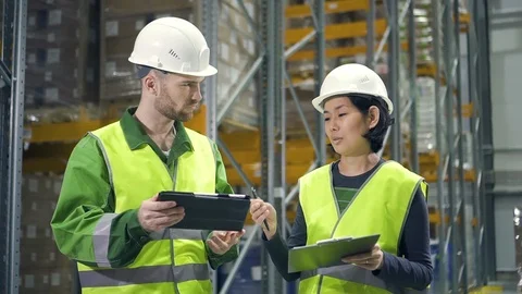 Two employees discussing work with tablet computer at logistics center warehouse Stock Footage 123226273