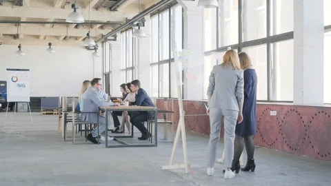 Two employees prepare a presentation on a glass board. In the background is a Stock Footage 109505476