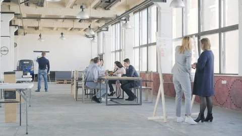 Two employees prepare a presentation on a glass board. In the background is a Stock Footage 109506034