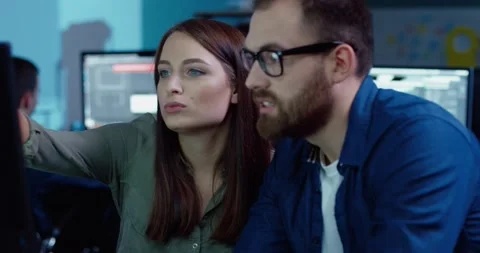 Two employees work together on project sitting at the same computer. Beautiful Video stock 140289519