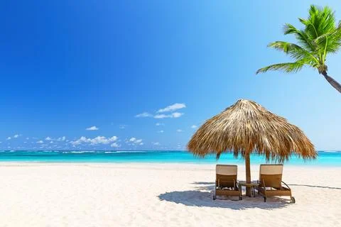 Two empty beach chairs on a summer sunny day at the beach in Punta Cana, Do.. Stock Photos