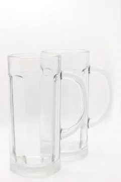 Two empty beer mugs with handles on a white background Stock Photos
