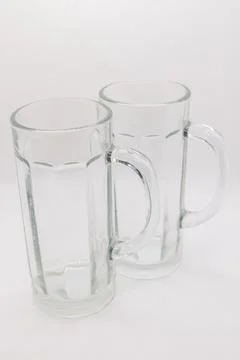 Two empty beer mugs with handles on a white background Stock Photos