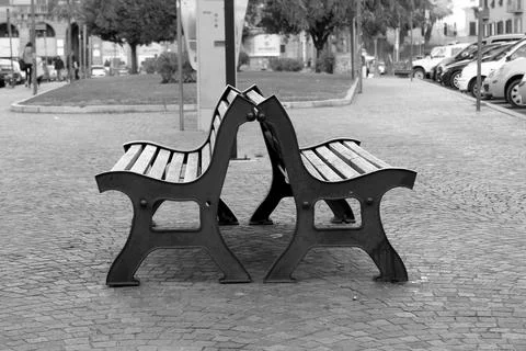 Two empty benches in a quiet square of Viterbo, Italy Stock Photos