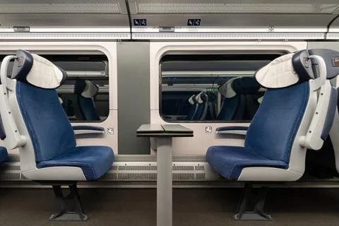Two empty blue passenger seats with table in high speed train interior Stock Photos