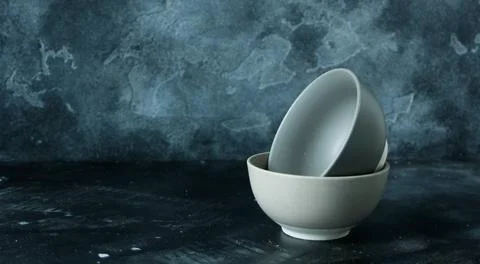Two empty bowls in dark background Stock Photos