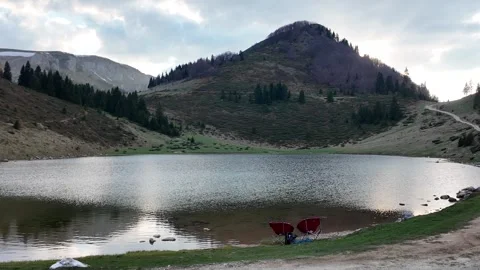 Two empty camping chairs against the backdrop of mountains. Stock Footage 317325867