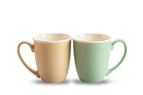 Two empty ceramic coffee mugs brown and green isolated on white background.. Foto stock