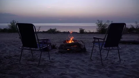Two empty chairs near the fireplace at sunset Stock Footage 145425201