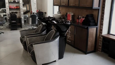 Two empty chairs with a wash basin at barbershop. 4K Stock Footage 104175500