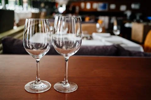 Two empty clean wine glasses on a wooden table. utensils for alcoholic beverages Stock Photos