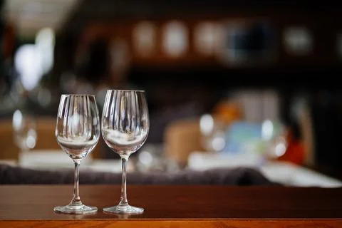 Two empty clean wine glasses on a wooden table. utensils for alcoholic beverages Stock Photos