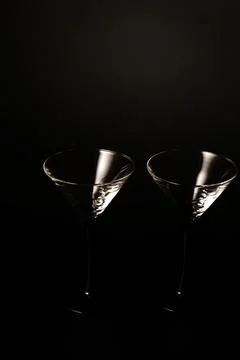 Two empty cocktail glasses on a black background. Studio shooting. Foto stock