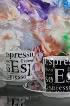 Two empty coffee cups  in front of colored paper 스톡 사진