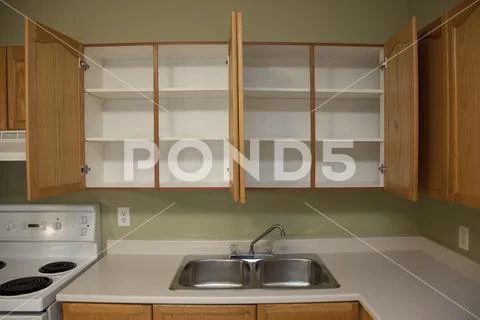 Two empty cupboards and a kitchen sink Stock Photos