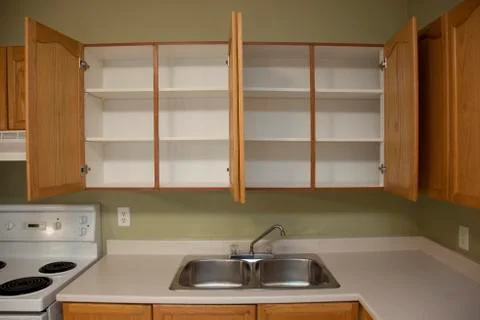 Two empty cupboards and a kitchen sink Stock Photos