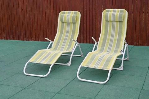 Two empty deck chair or chaise longue. Concept of recreation, tanning in ya.. Stock Photos