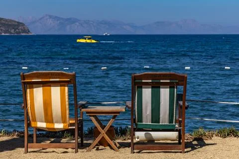 Two empty deck chairs on the shores of the Aegean Sea, relaxing in Turgutre.. Фото