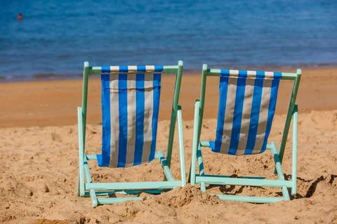 Two empty deckchairs facing the sea Two empty deckchairs facing the sea ,m... Stock Photos