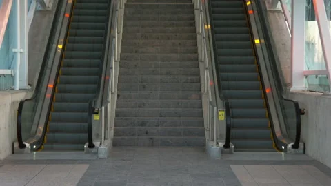 Two empty escalators waiting for commuters to show up.  One going up and Stock Footage 131281448