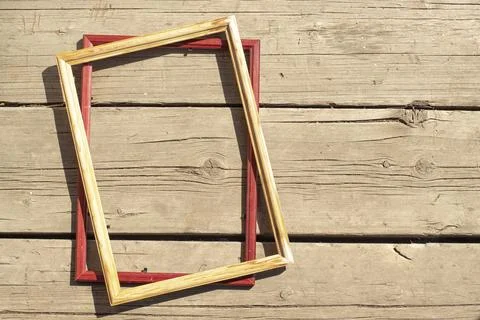 Two empty frames on the background of old boards on a sunny day 스톡 사진