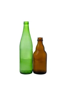 Two empty glass bottles, one green and one brown, stand side-by-side agains.. Stock Photos
