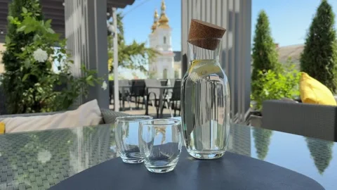 Two empty glasses and a bottle of water on the table Stock Footage 321560537