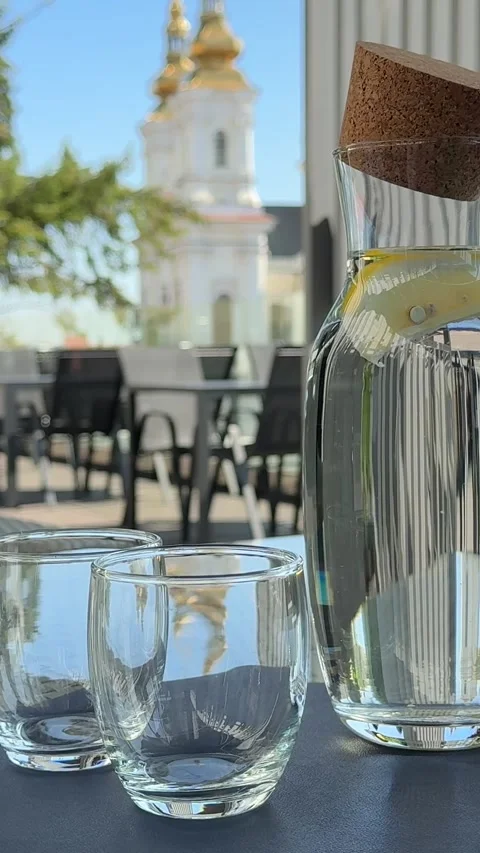 Two empty glasses and a bottle of water on the table Stock Footage 323288752