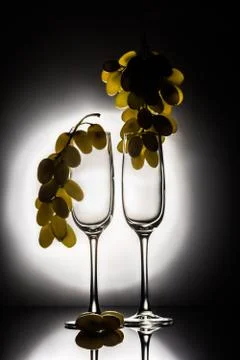 Two empty glasses and grapes Stock Photos