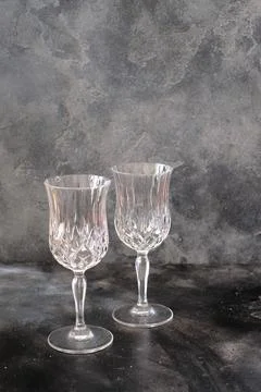 Two empty glasses on dark color background Stock Photos