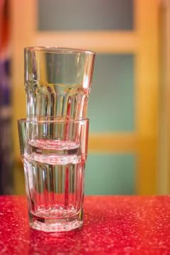 Two empty glasses on a red bar counter Stock Photos