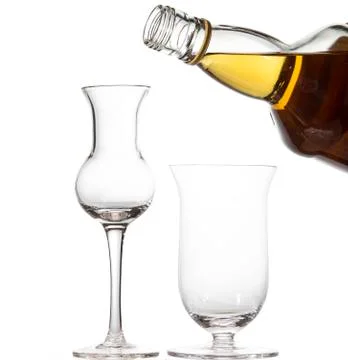 Two empty glasses in the shape of a tulip. A bottle of whiskey. Stock Photos