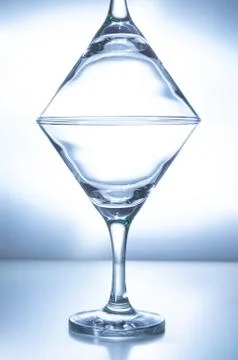 Two empty glasses stand on top of each other Stock Photos